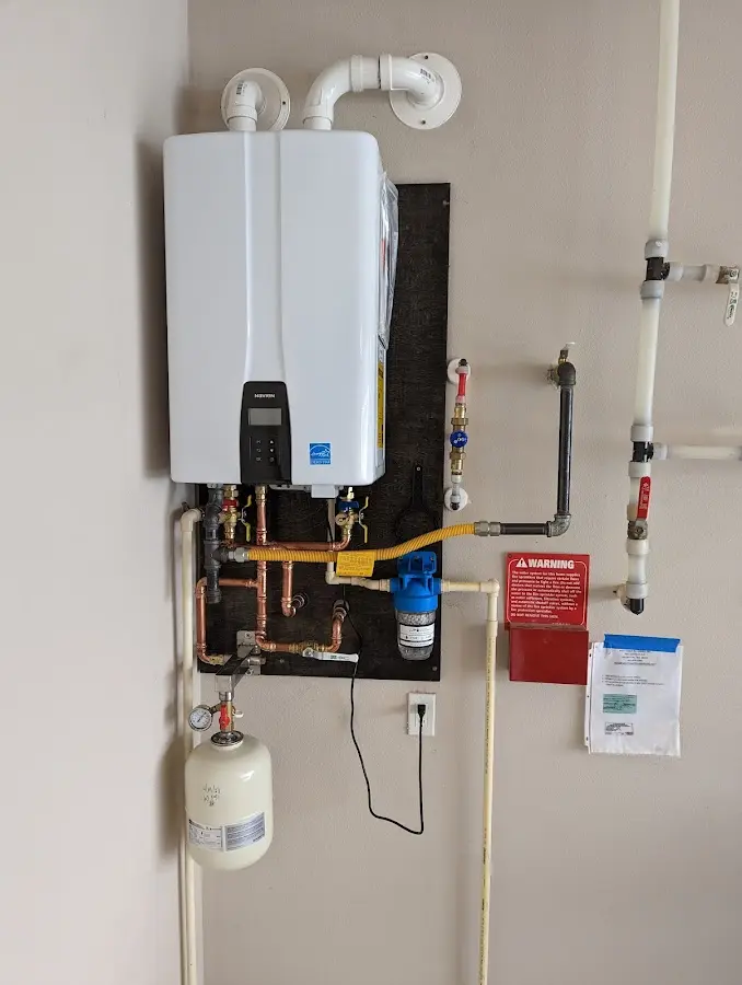 Professional plumber installing copper piping in a Timnath home